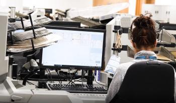 Female NHSBSA employee working on scanner